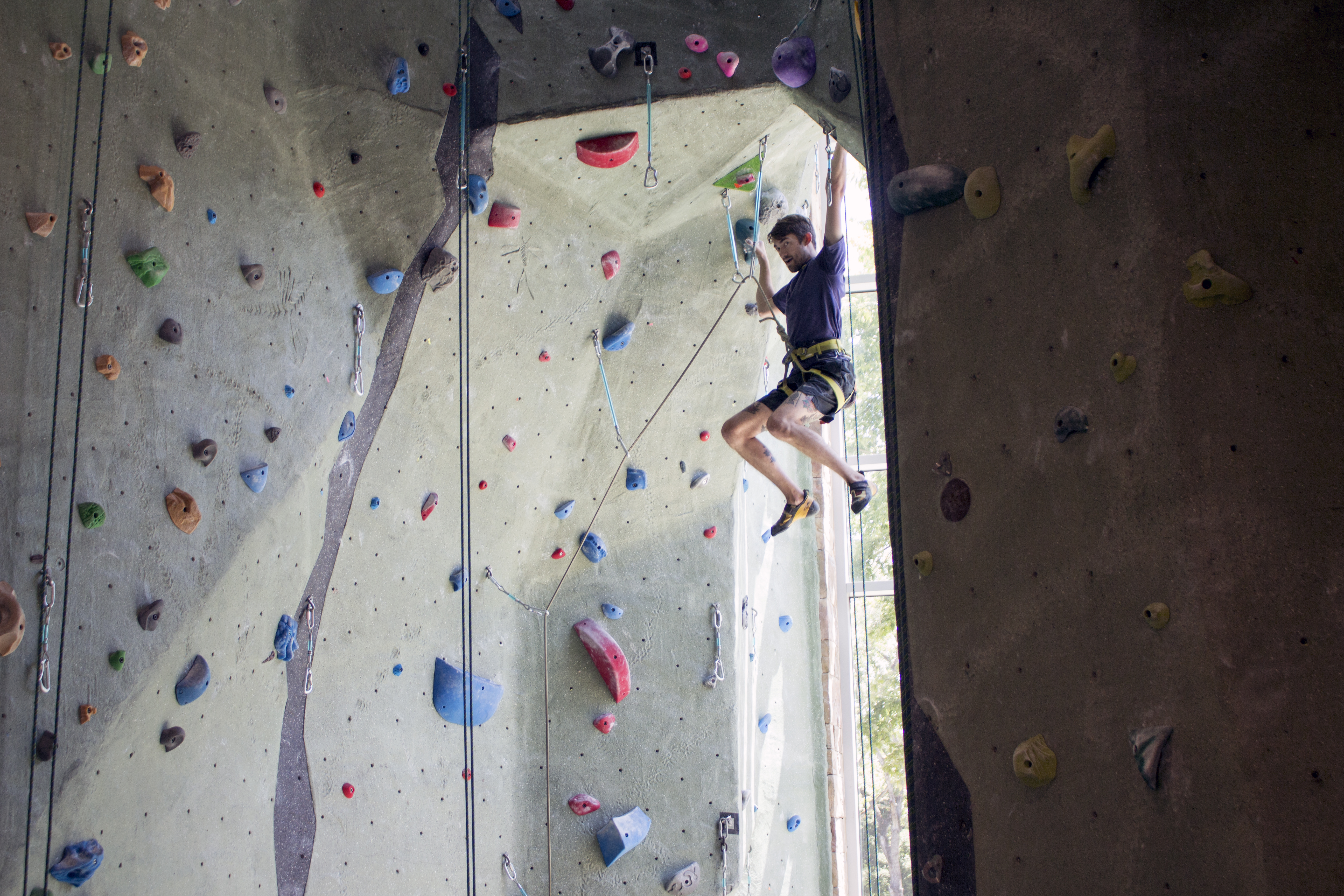 student on rock wall