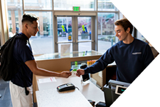 Students exchanging an ID card at member services