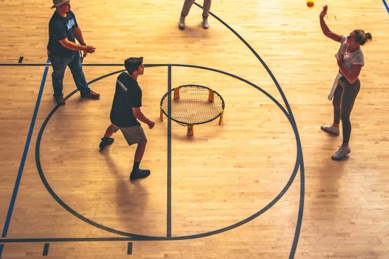 students playing spikeball indoors