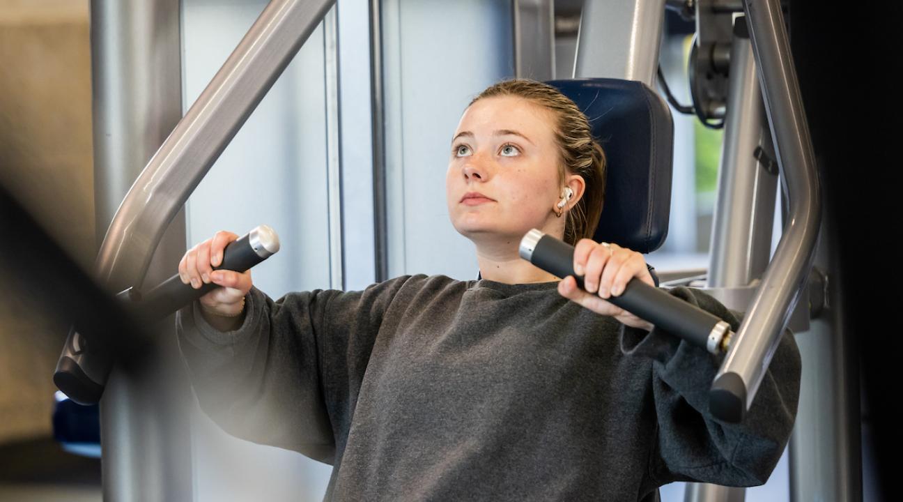 Student using exercise machine