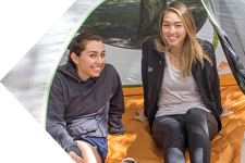 two students in a tent