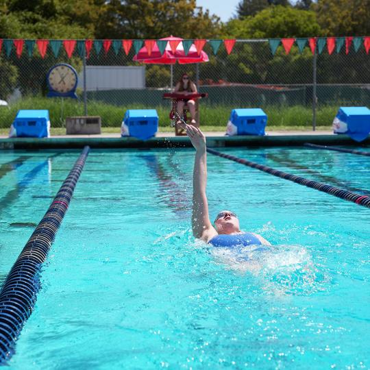 a person swimming in a lap lane of a pool