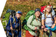 three girls wear backpacks