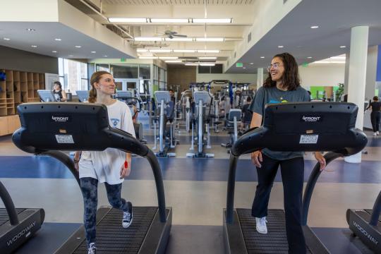 students walking on treadmills at the rec center