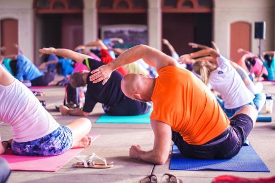 a group of people doing yoga together