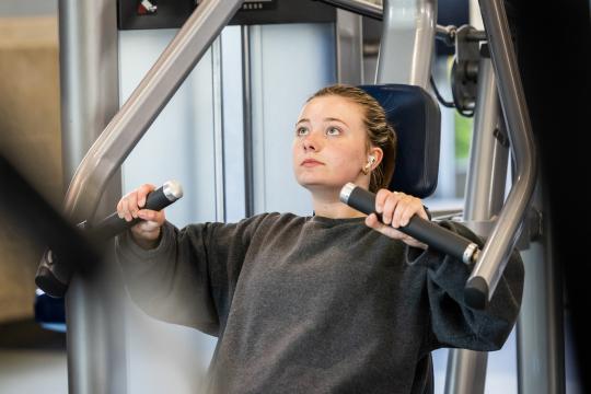 Student using exercise machine