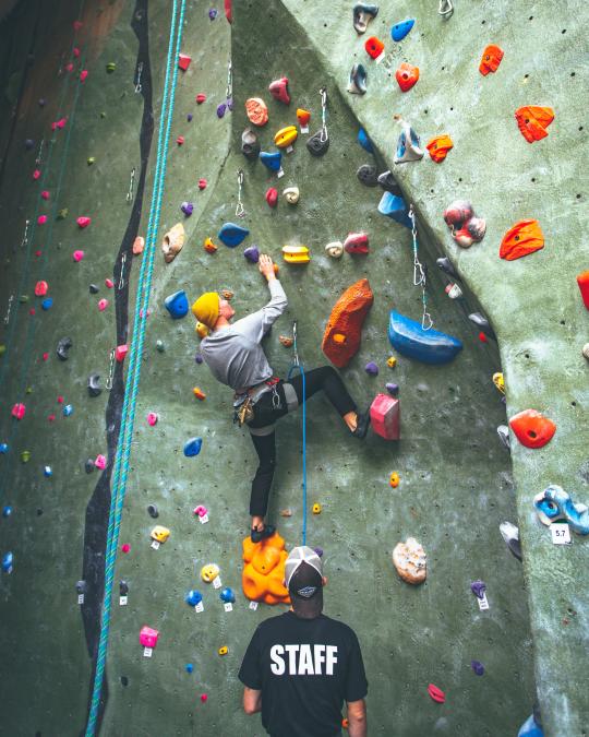 person on climbing wall at rec
