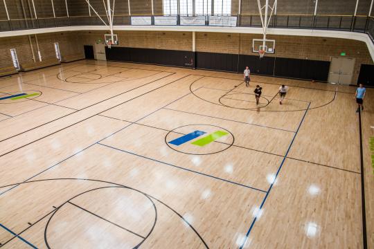 people playing basketball on basketball court
