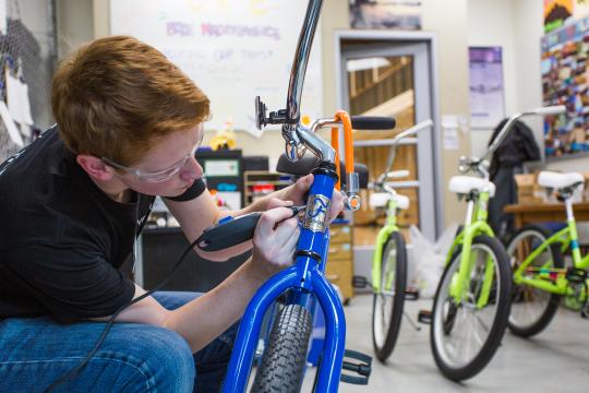 Student fixing bike