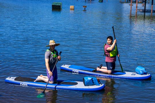 two students on paddleboards