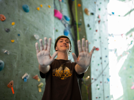 student at climbing wall