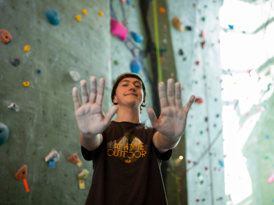 student at climbing wall student at climbing wall