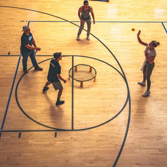 students playing spikeball indoors