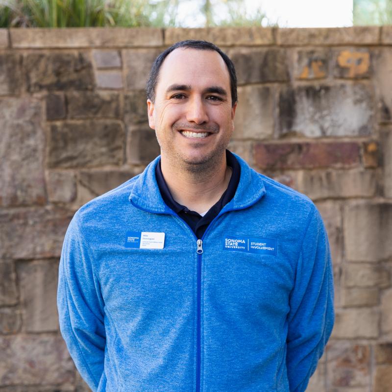 Mike Dominguez in front of brick wall