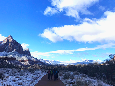 Group of students hiking by the side of a snowy mountain