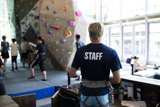students and staff at climbing wall